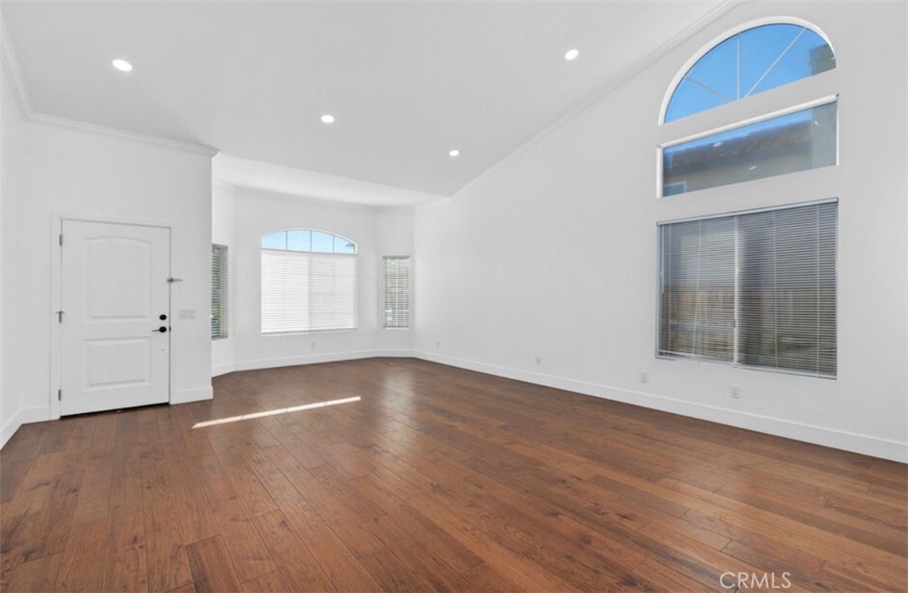 30894 Wellington Circle Temecula, CA 92591 - Photo 3 of 28 a view of an empty room with wooden floor and a window