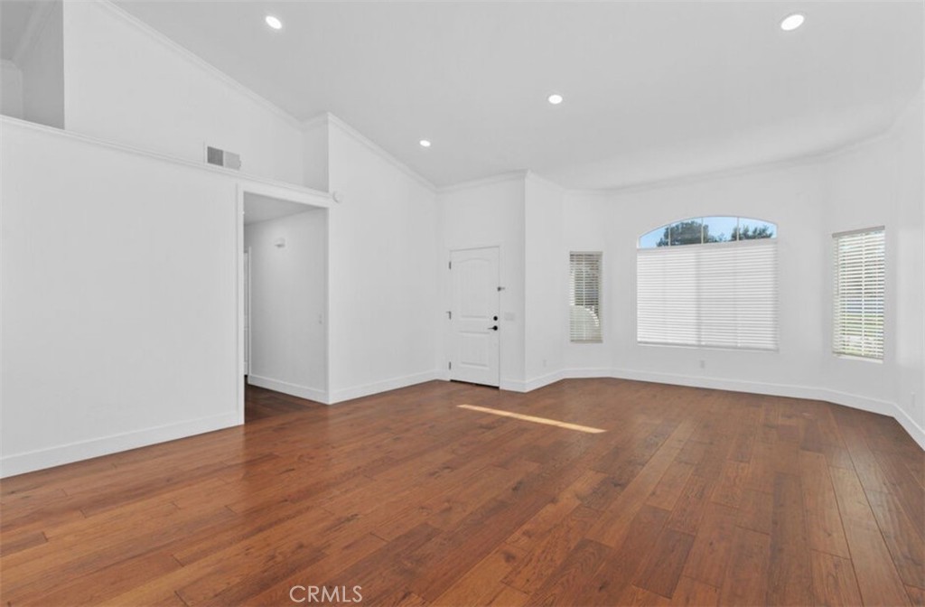 30894 Wellington Circle Temecula, CA 92591 - Photo 5 of 28 a view of an empty room with wooden floor and a window