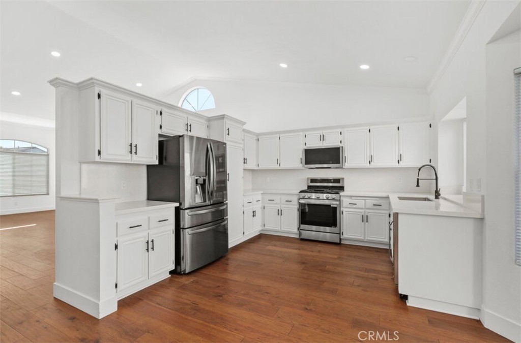 30894 Wellington Circle Temecula, CA 92591 - Photo 9 of 28 a kitchen with white cabinets and stainless steel appliances