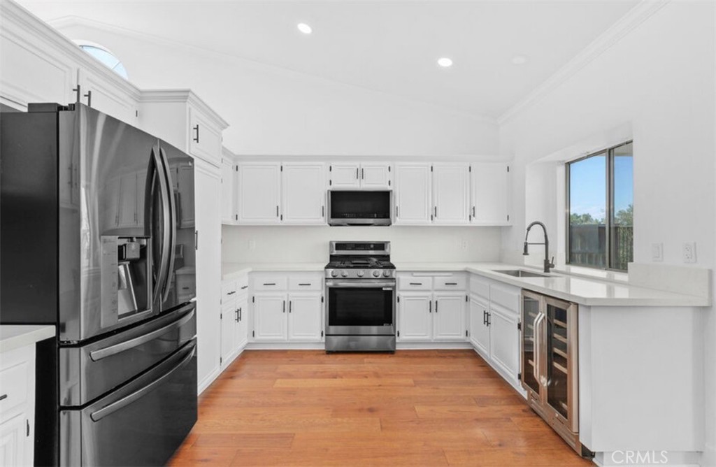 30894 Wellington Circle Temecula, CA 92591 - Photo 10 of 28 a kitchen with stainless steel appliances a stove sink and refrigerator