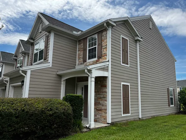 a front view of a house with a garden