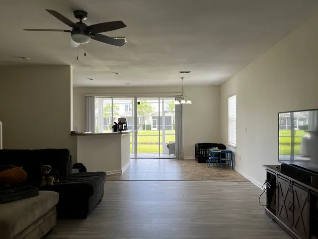 a kitchen with stainless steel appliances granite countertop a refrigerator a sink a stove and island