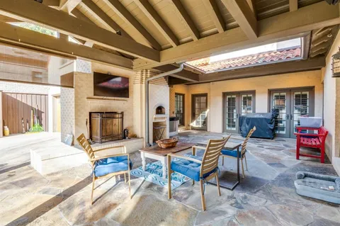 a outdoor space with patio furniture and a fireplace