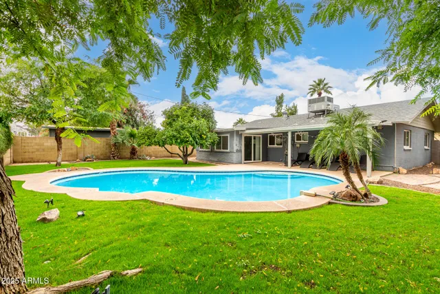 a view of pool with a yard