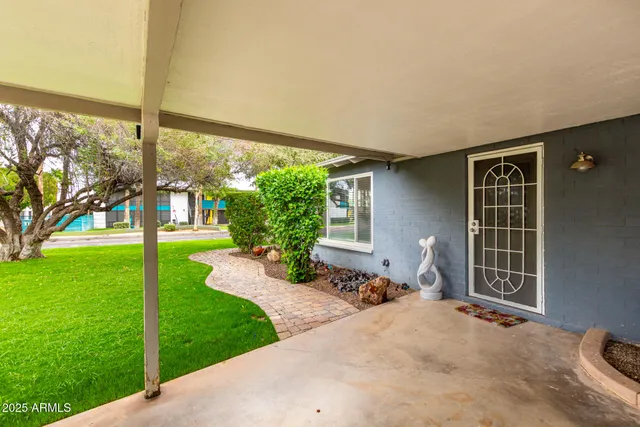 a view of a backyard with garden and patio