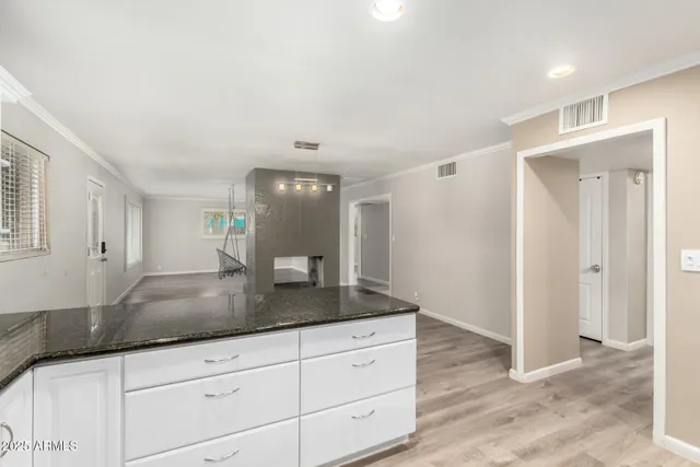 a view living room with granite countertop cabinets and sink