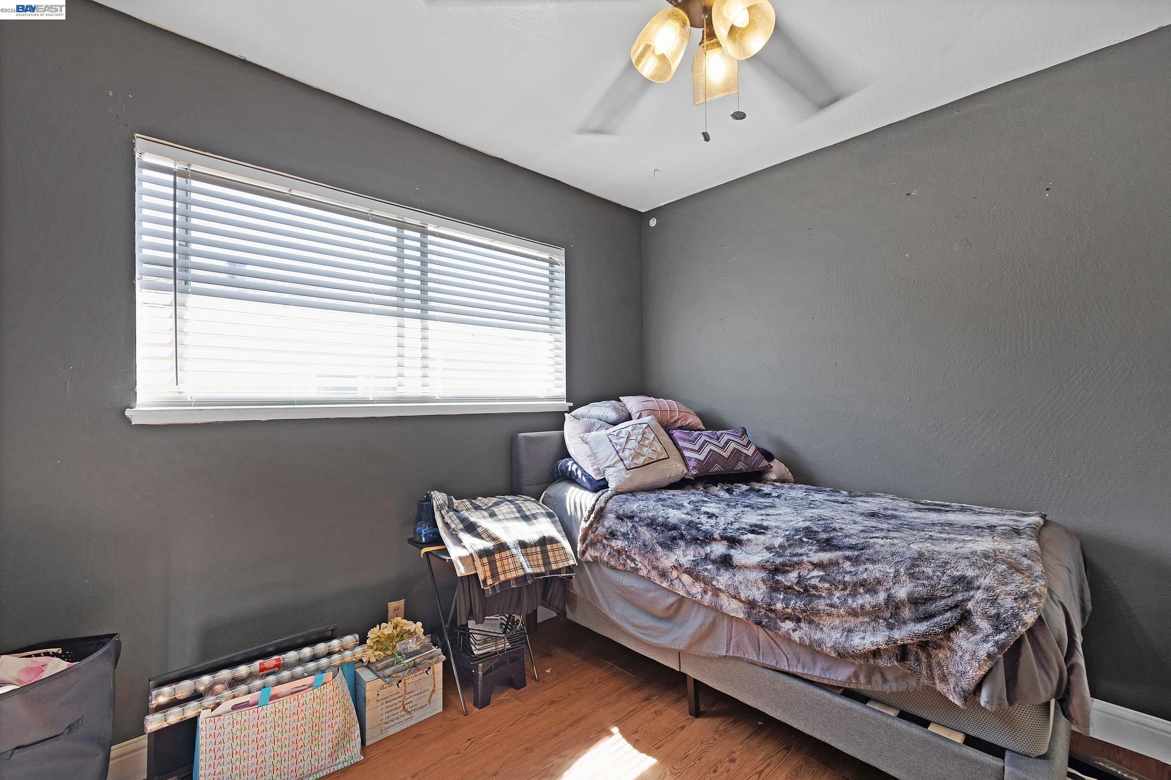 a bedroom with a bed and a window
