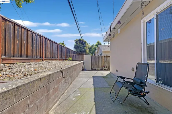 a view of a balcony with chair and front door