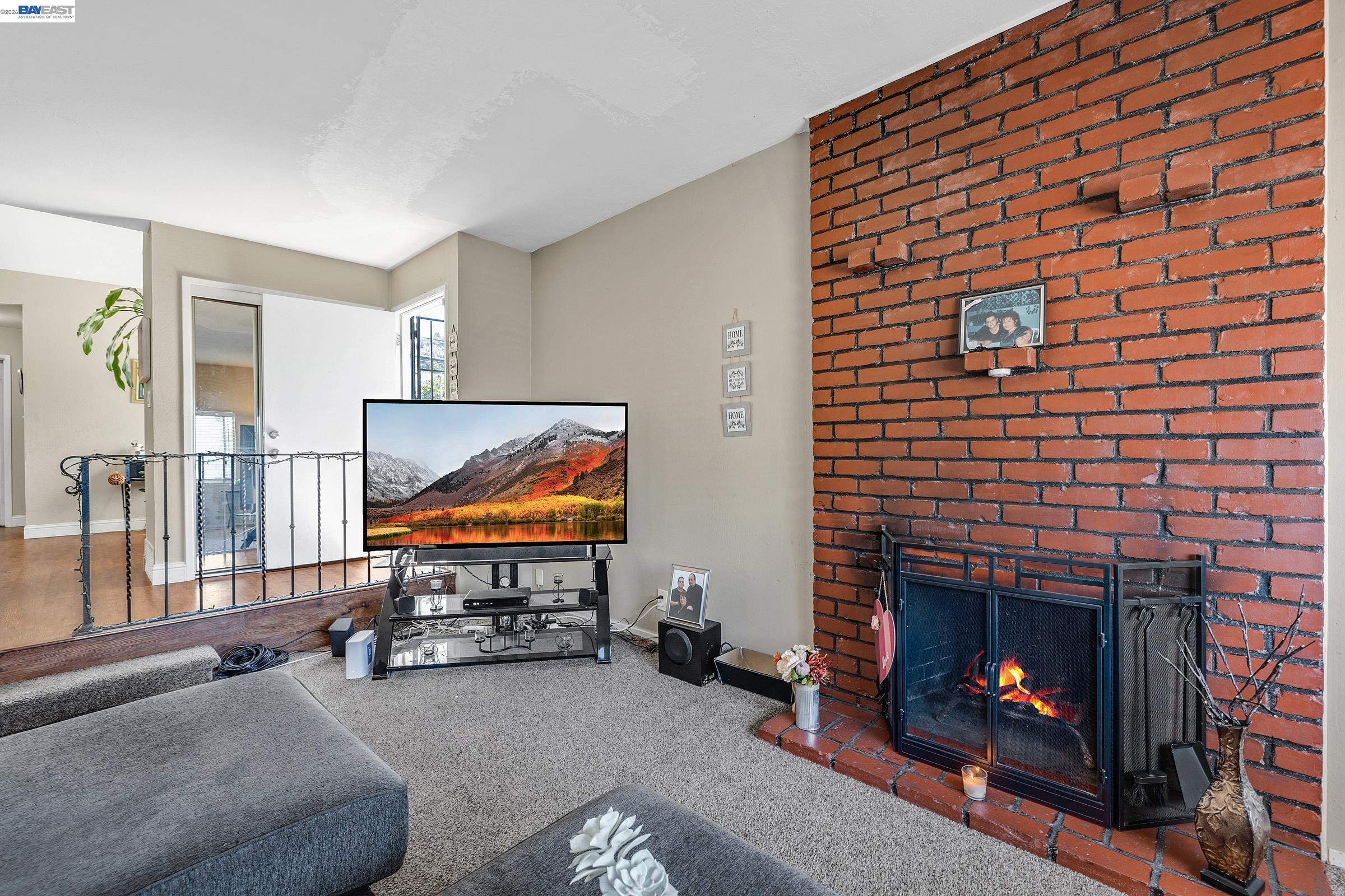 30236 Vanderbilt Street Hayward, CA 94544 - Photo 40 of 46 a living room with furniture a flat screen tv and a fireplace