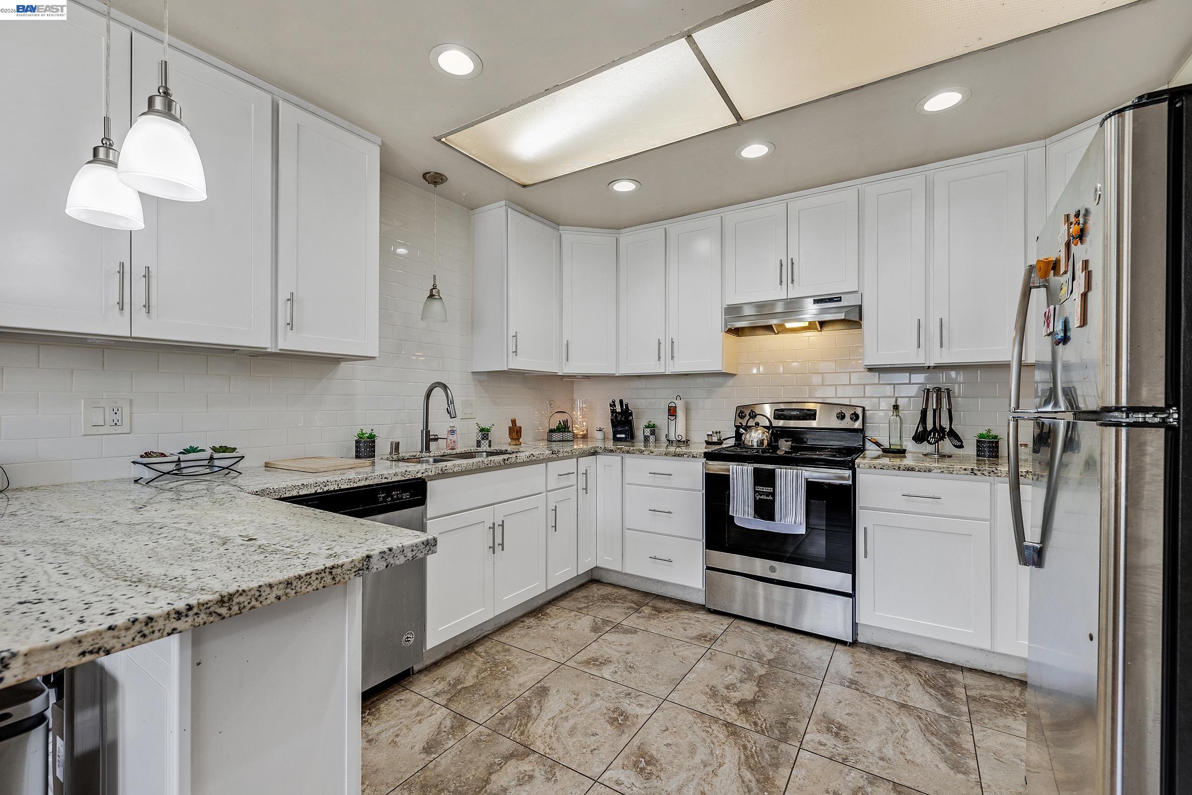 30236 Vanderbilt Street Hayward, CA 94544 - Photo 45 of 46 a kitchen with a stove a sink and a refrigerator