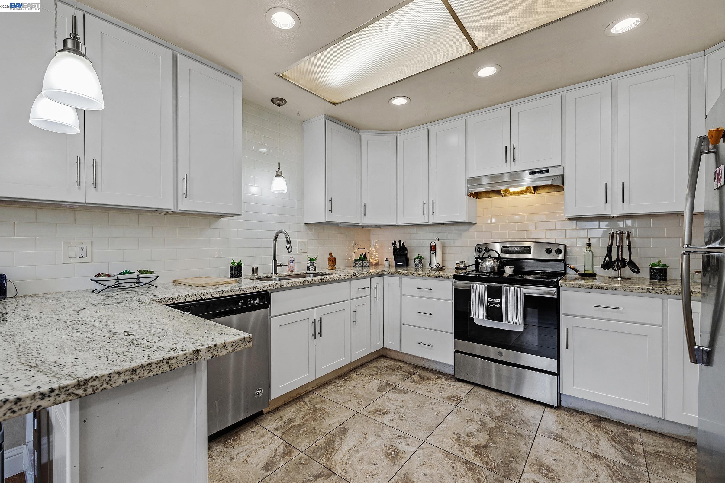 30236 Vanderbilt Street Hayward, CA 94544 - Photo 10 of 46 a kitchen with granite countertop sink stainless steel appliances and white cabinets