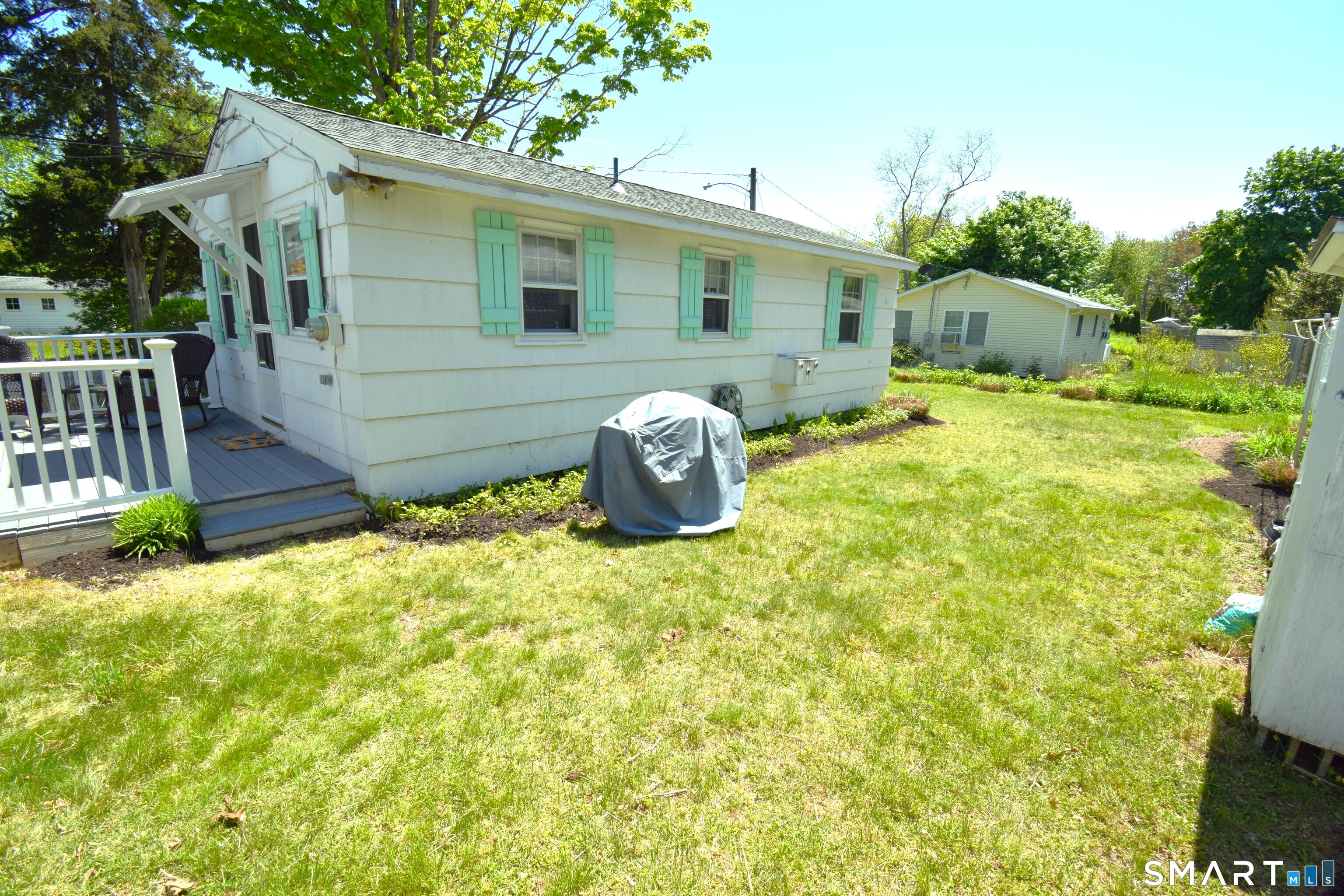 50 East Street Madison, CT 06443 - Photo 3 of 26 a backyard of a house with table and chairs plants