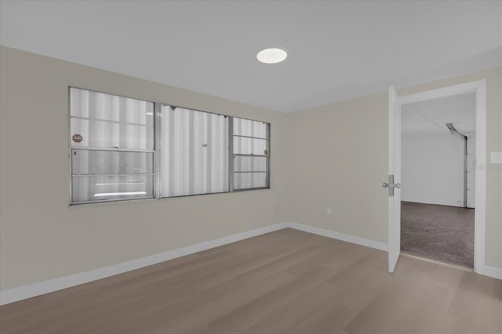 1610 Glenwood Road DeLand, FL 32720 - Photo 13 of 35 wooden floor in an empty room with a window