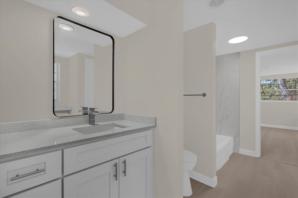 1610 Glenwood Road DeLand, FL 32720 - Photo 17 of 35 a bathroom with a sink a toilet and a mirror