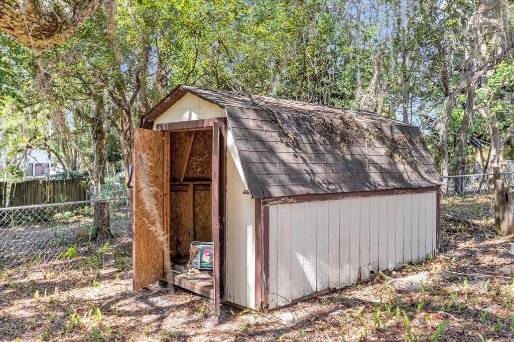 1610 Glenwood Road DeLand, FL 32720 - Photo 30 of 35 a wooden house with a large tree and wooden fence
