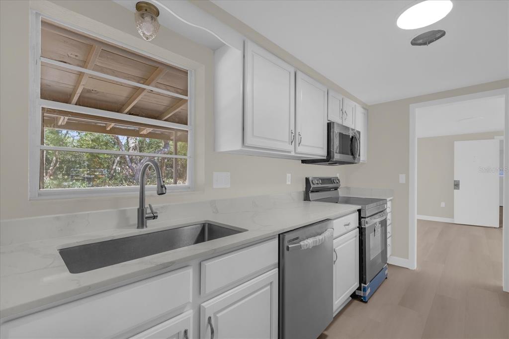 1610 Glenwood Road DeLand, FL 32720 - Photo 6 of 35 a kitchen with a sink cabinets and window