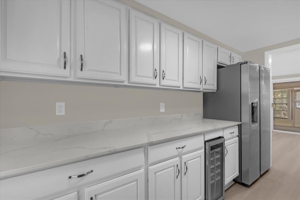 1610 Glenwood Road DeLand, FL 32720 - Photo 7 of 35 a kitchen with stainless steel appliances white cabinets and a sink