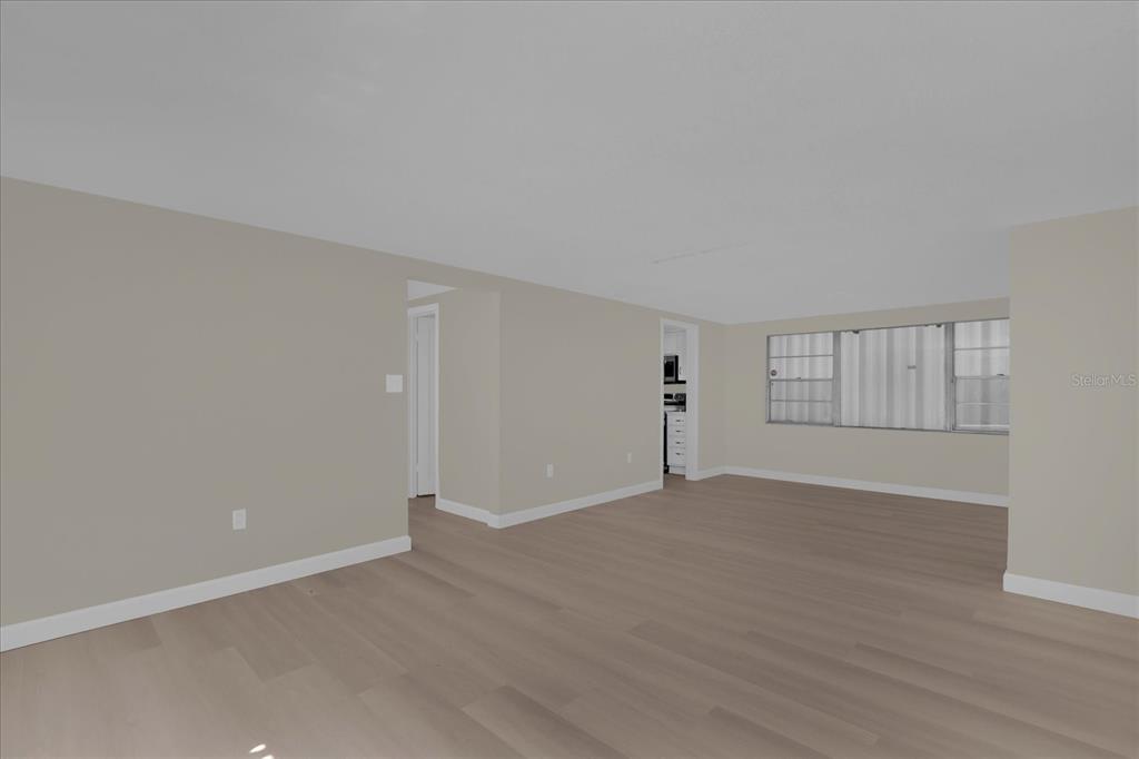 1610 Glenwood Road DeLand, FL 32720 - Photo 9 of 35 a view of an empty room with wooden floor and window
