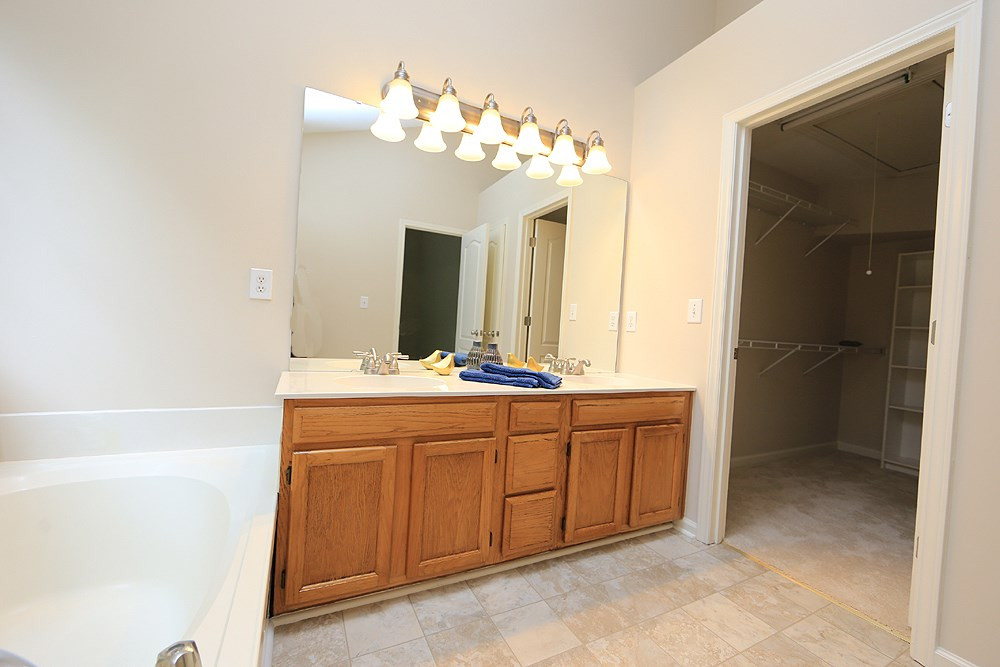 9712 Miranda Drive Raleigh, NC 27617 - Photo 16 of 25 His and hers vanities and a huge walk-in closet with built-in shelving complete the master bathroom. Master Bath/Spa