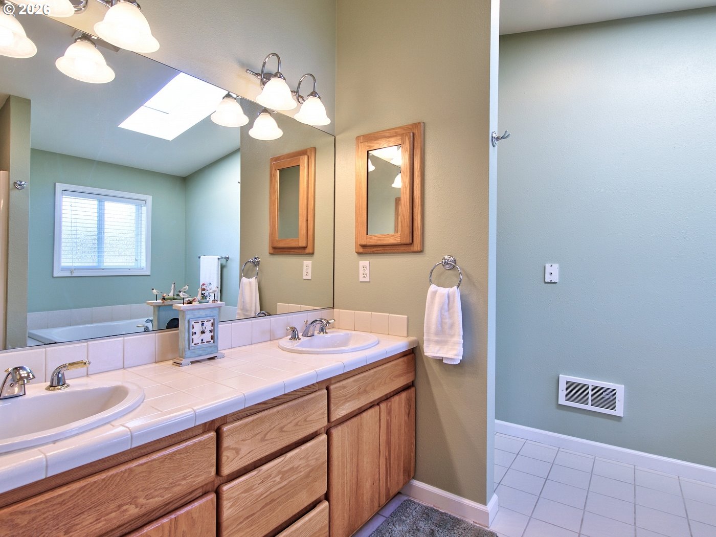 5185 Main Street Bay City, OR 97107 - Photo 23 of 48 a bathroom with a sink a vanity and mirror