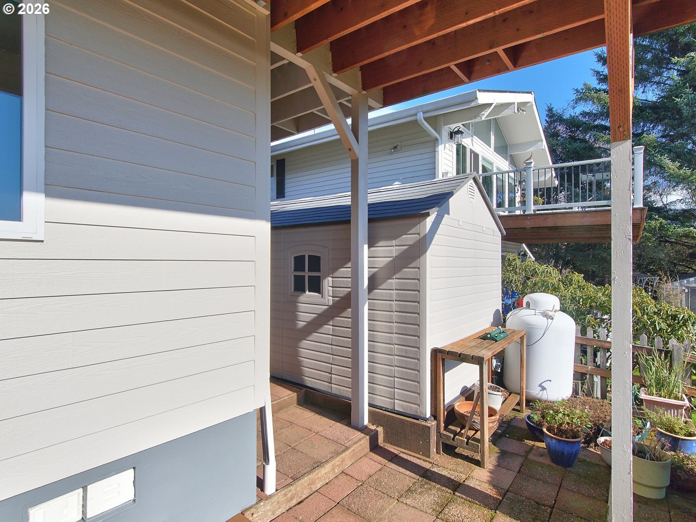5185 Main Street Bay City, OR 97107 - Photo 43 of 48 a view of a patio with table and chairs with wooden floor and fence