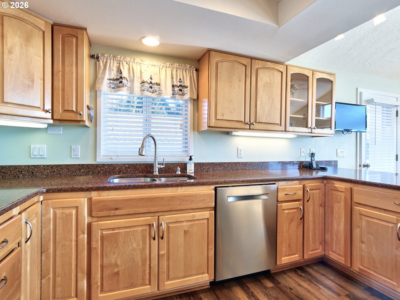5185 Main Street Bay City, OR 97107 - Photo 9 of 48 a kitchen with stainless steel appliances granite countertop a sink and cabinets with wooden floor