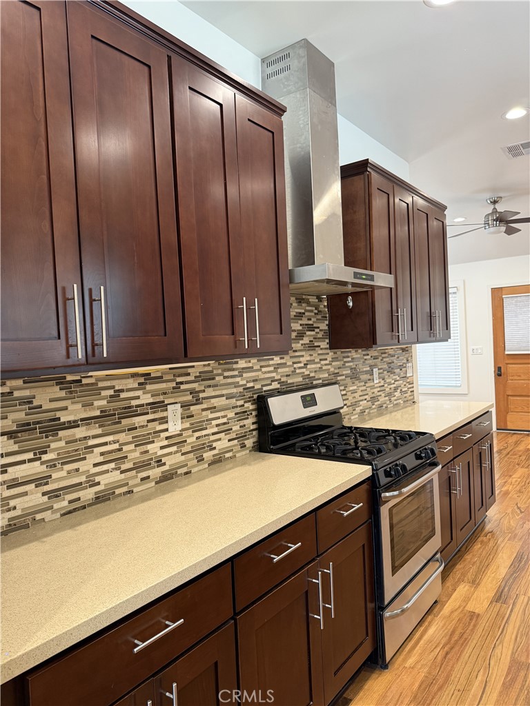 686 Atchison Street Pasadena, CA 91104 - Photo 4 of 11 a kitchen with stainless steel appliances granite countertop a sink stove and refrigerator