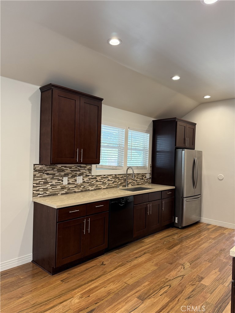 686 Atchison Street Pasadena, CA 91104 - Photo 5 of 11 a kitchen with stainless steel appliances granite countertop a stove a refrigerator and a wooden cabinets