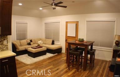 686 Atchison Street Pasadena, CA 91104 - Photo 6 of 11 a living room with furniture and a dining table with wooden floor