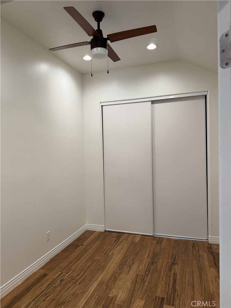 686 Atchison Street Pasadena, CA 91104 - Photo 8 of 11 an empty room with a ceiling fan and wooden floor
