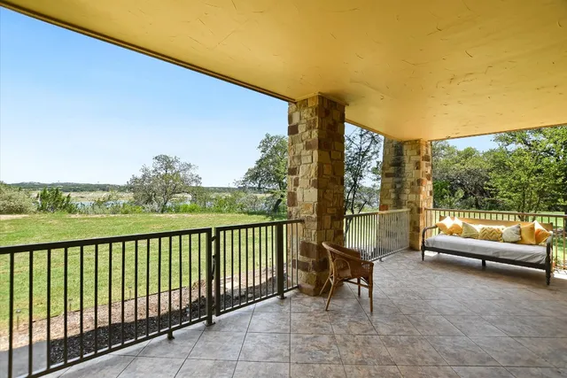 a view of a chairs and table in patio with a lake view