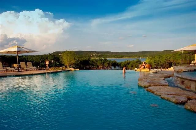an aerial view of residential houses with outdoor space and lake view