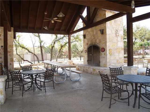 a view of a patio with table and chairs and couches with wooden floor