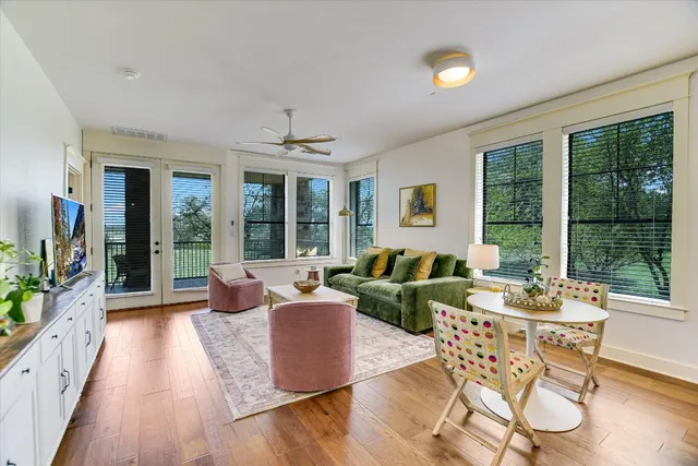 a living room with furniture and large windows