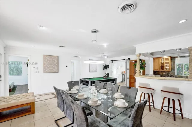 a kitchen with granite countertop a sink a counter top space appliances and cabinets