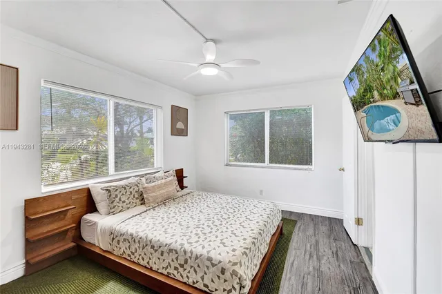 a bedroom with a bed and a large mirror