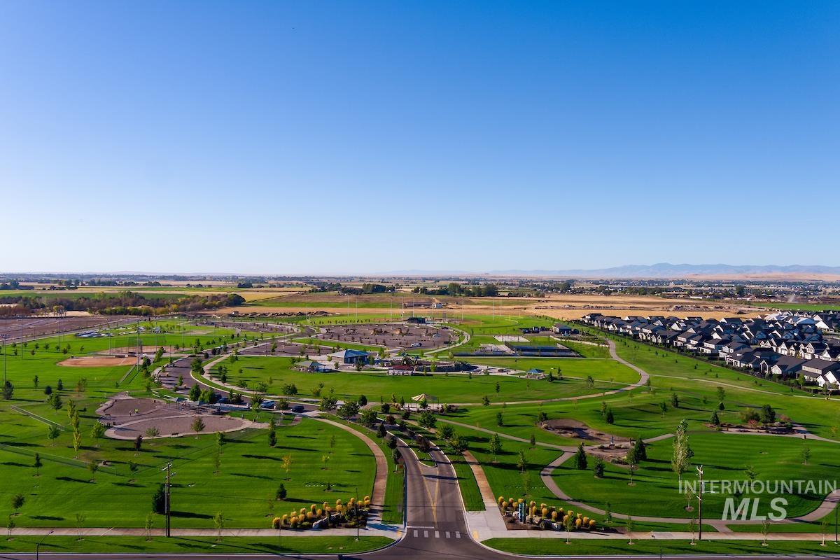 1735 East Acme Street Meridian, ID 83642 - Photo 3 of 8 Expansive parkland featuring extensive green spaces, paved walking paths, multiple sports fields, and a modern residential development bordering the park