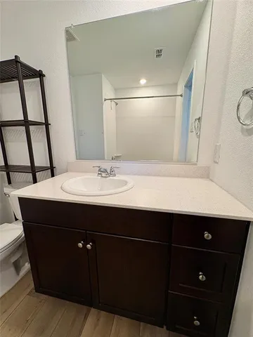 a bathroom with a sink vanity and mirror