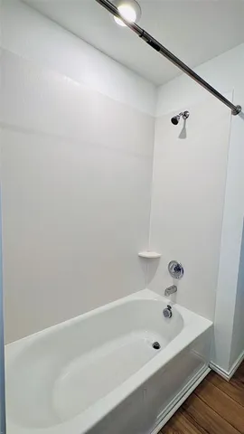 a bathroom with a tub and a shower