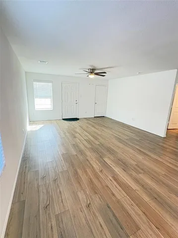 a view of an empty room and wooden floor