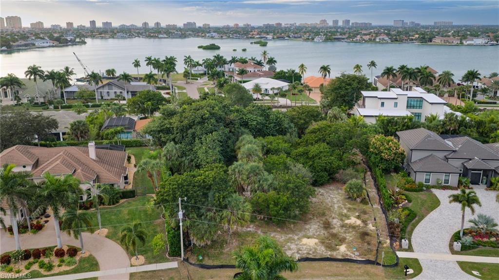 an aerial view of a house with outdoor space and lake view