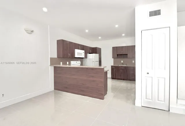 a large bathroom with a large mirror vanity and a shower