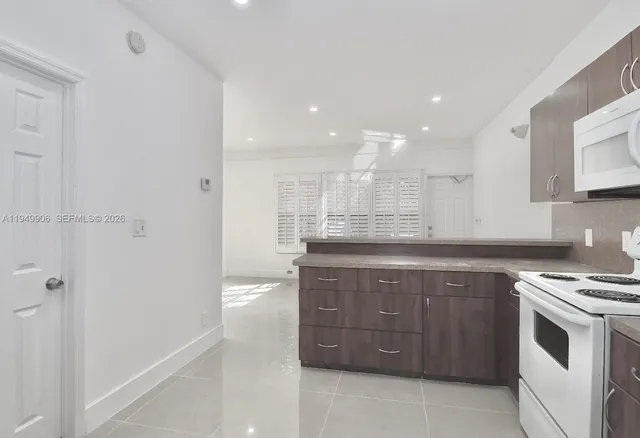 a kitchen with a sink and a stove top oven