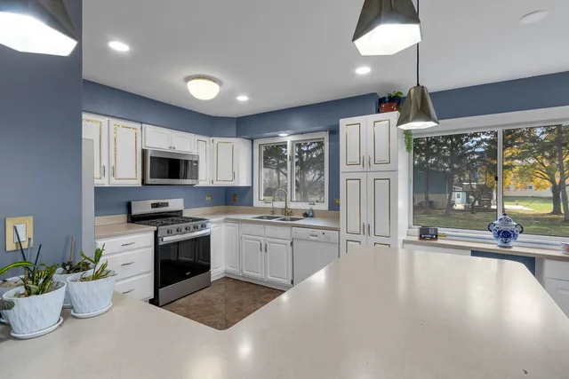 an empty room with a fireplace and a chandelier