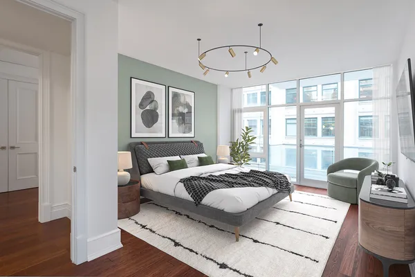 a bedroom with a bed and wooden floor