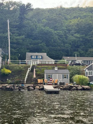 a view of a lake with a yard and wooden fence