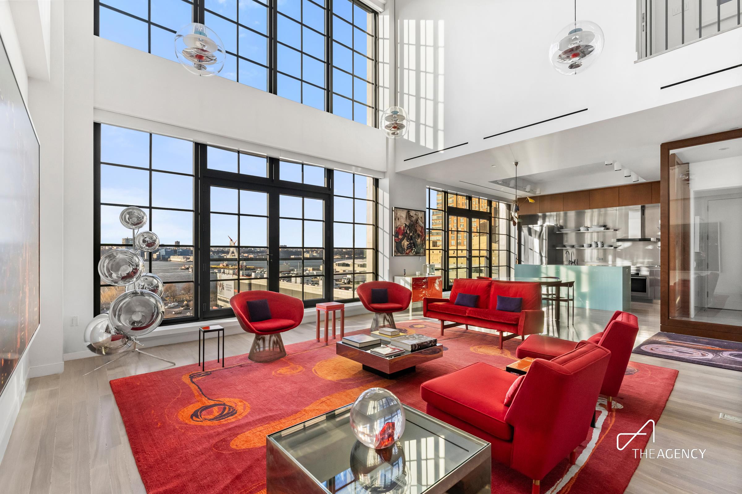 a dining room with furniture water view and large windows