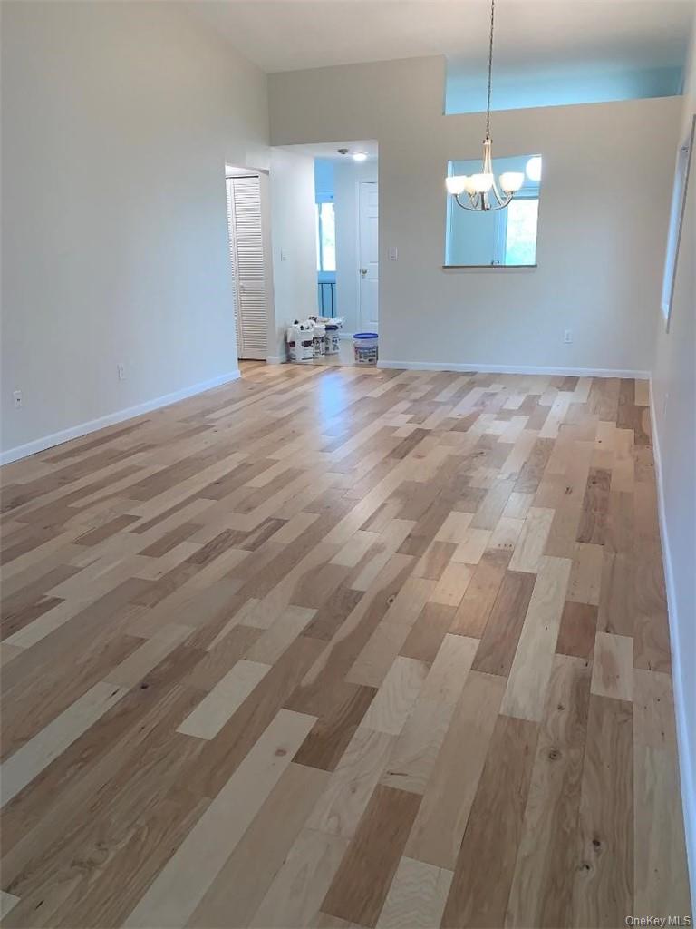 85 North Middletown Road, Unit D2 Nanuet, NY 10954 - Photo 3 of 14 Huge living room with cathedral ceilings, a dining area and wood floors throughout