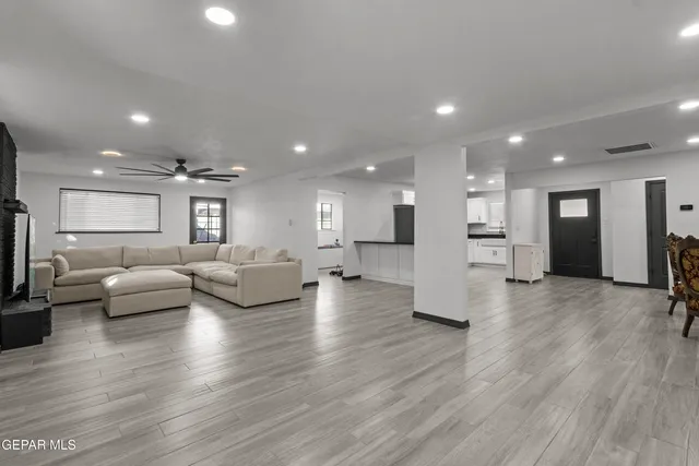 a living room with furniture and wooden floor