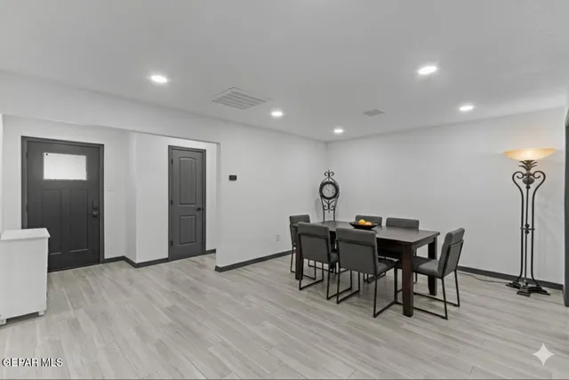 a view of a dining room with furniture and wooden floor